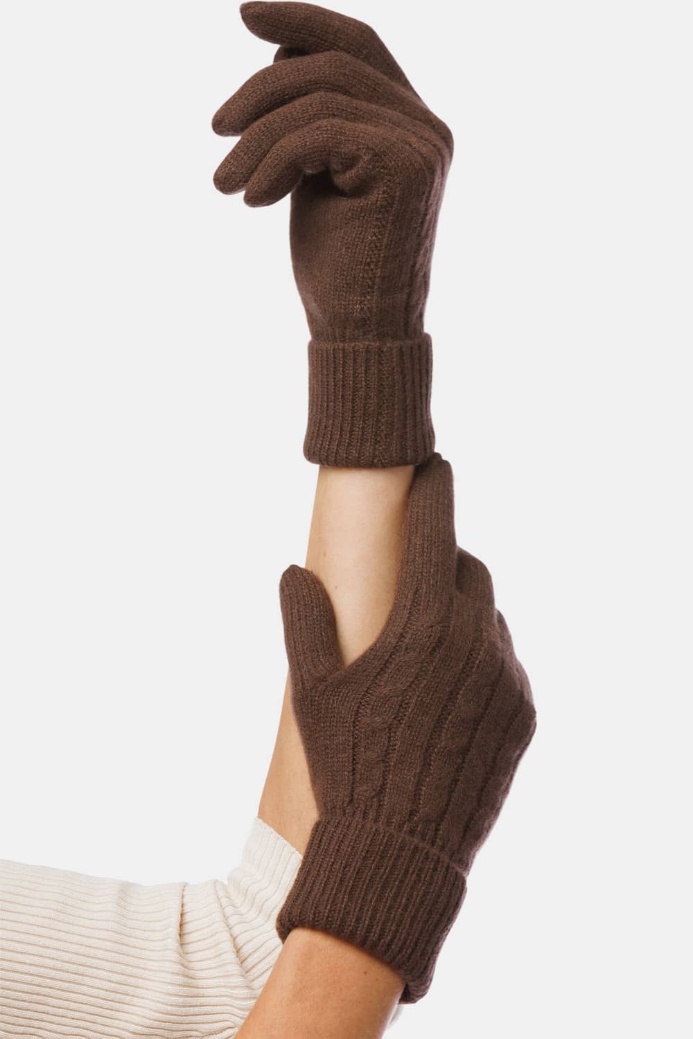 Woman's hands wearing Fishers Finery 100% cashmere cable knit brown gloves with rolled cuff