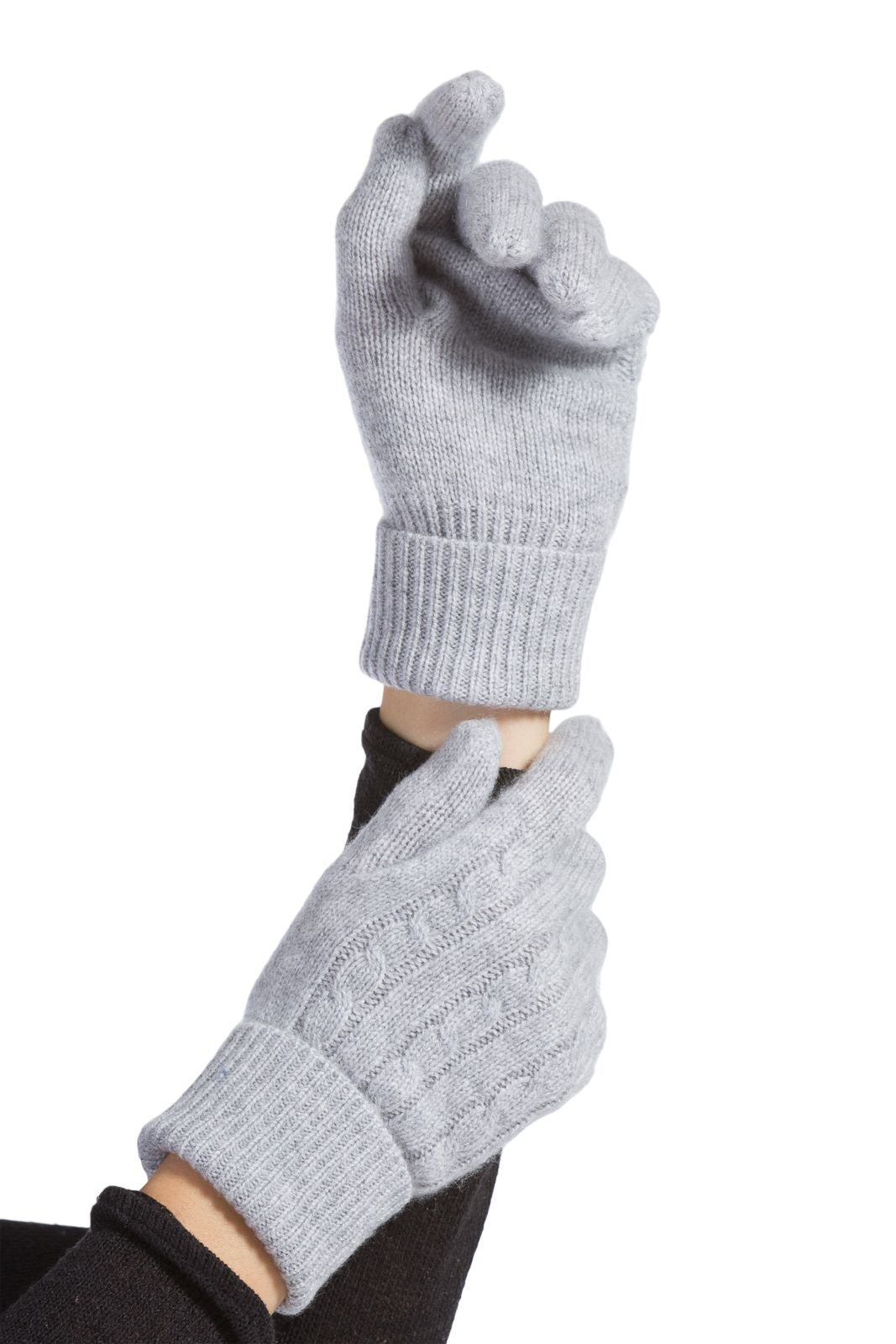 Woman's hands wearing Fishers Finery 100% cashmere cable knit winter gloves in light grey color